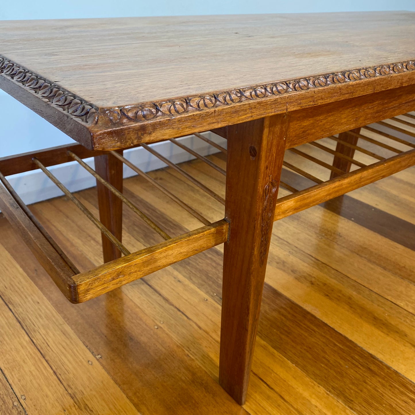 Vintage teak coffee table with magazine rack and carved details