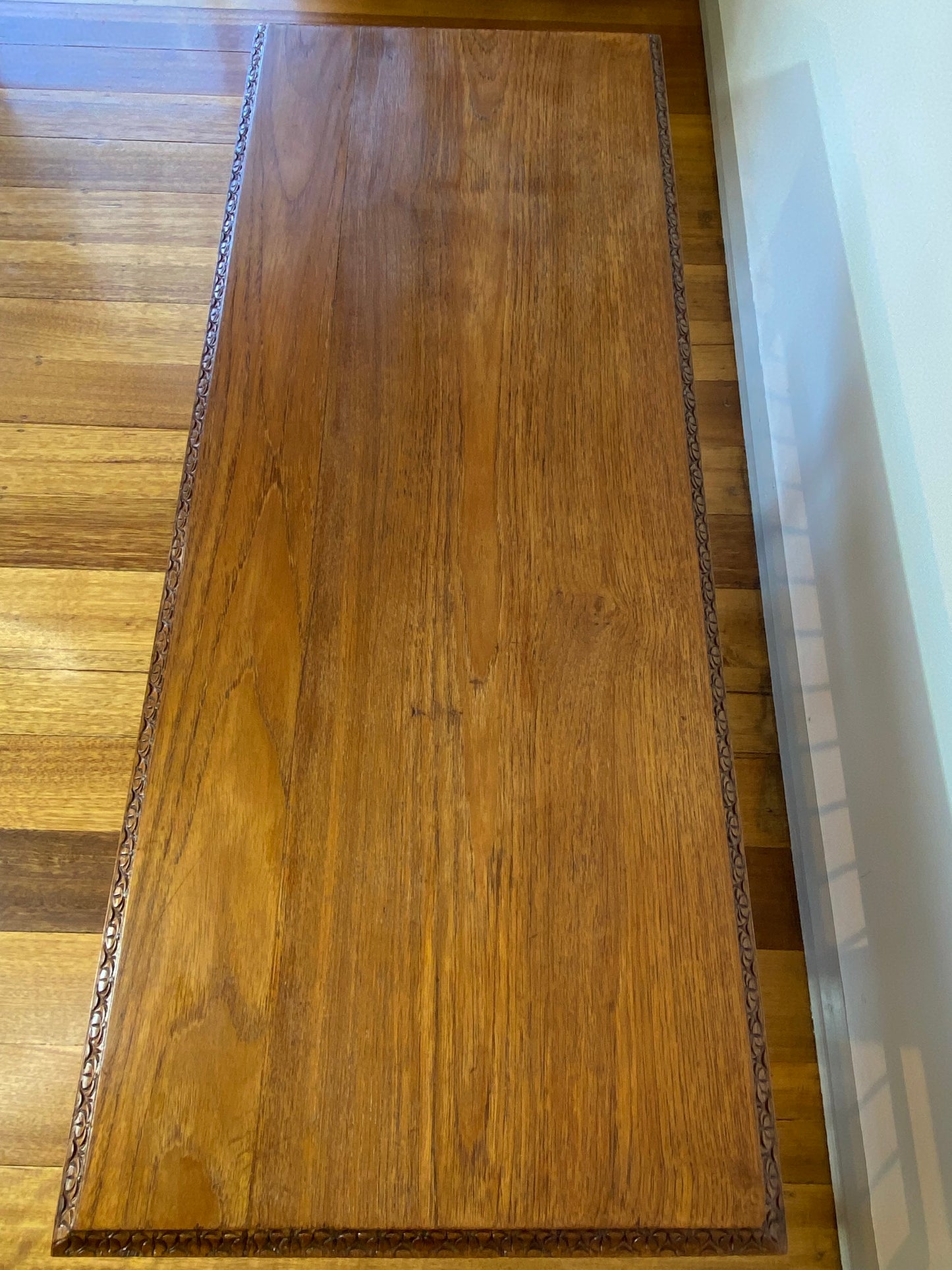 Vintage teak coffee table with magazine rack and carved details