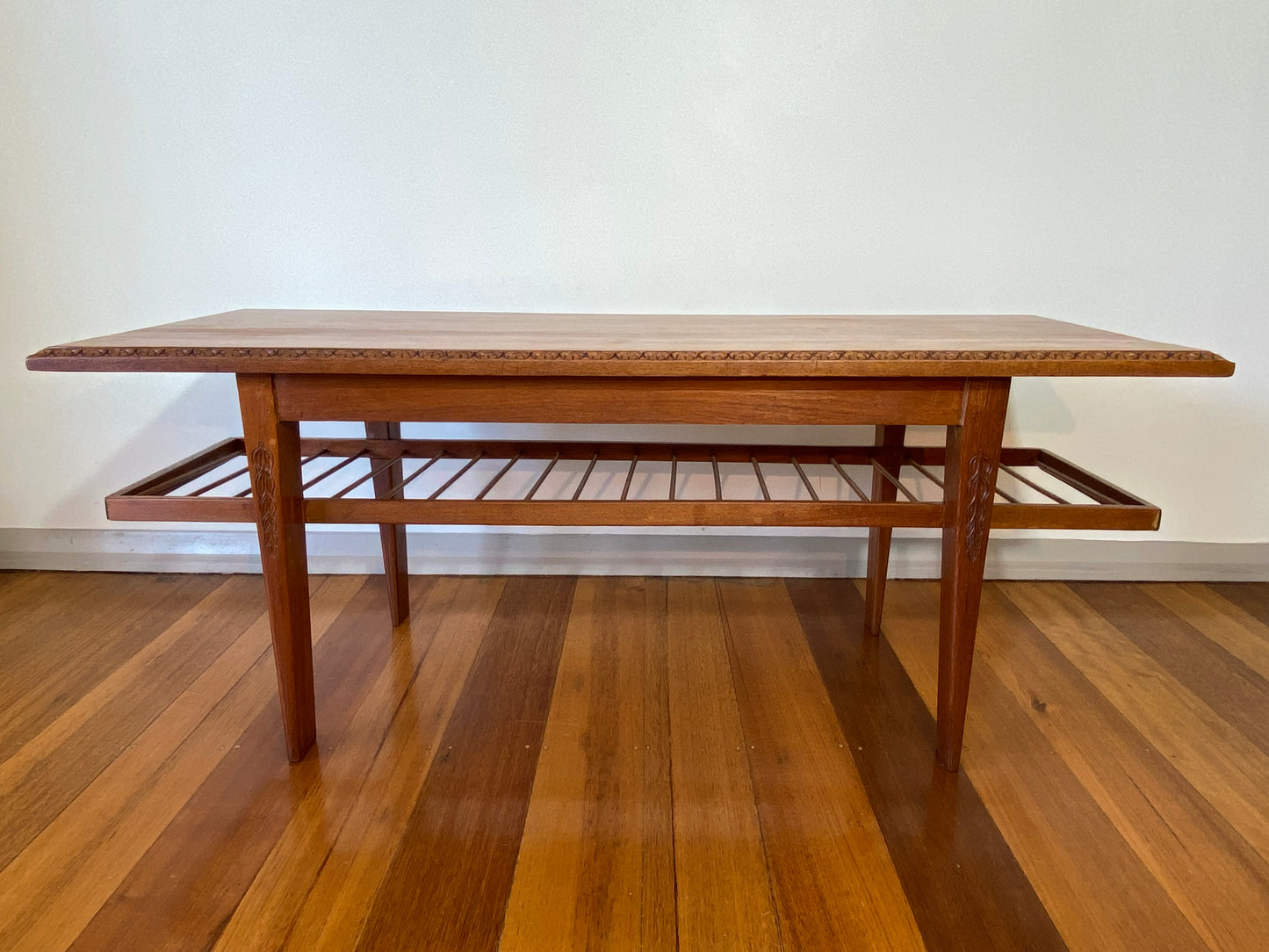 Vintage teak coffee table with magazine rack and carved details