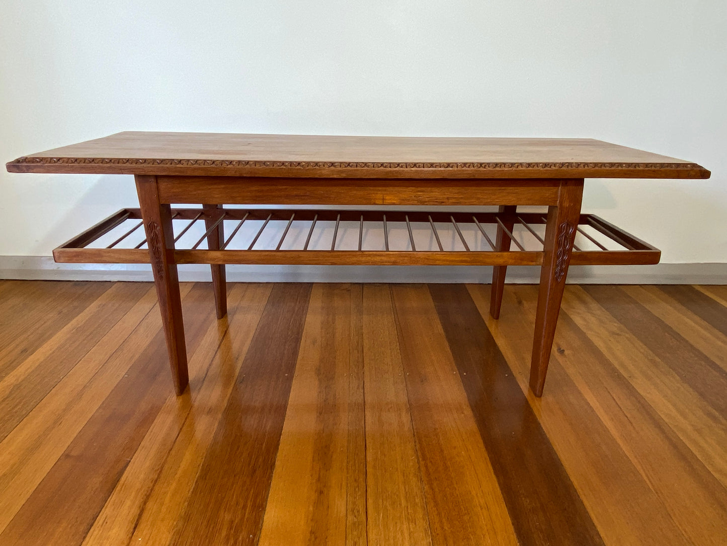 Vintage teak coffee table with magazine rack and carved details